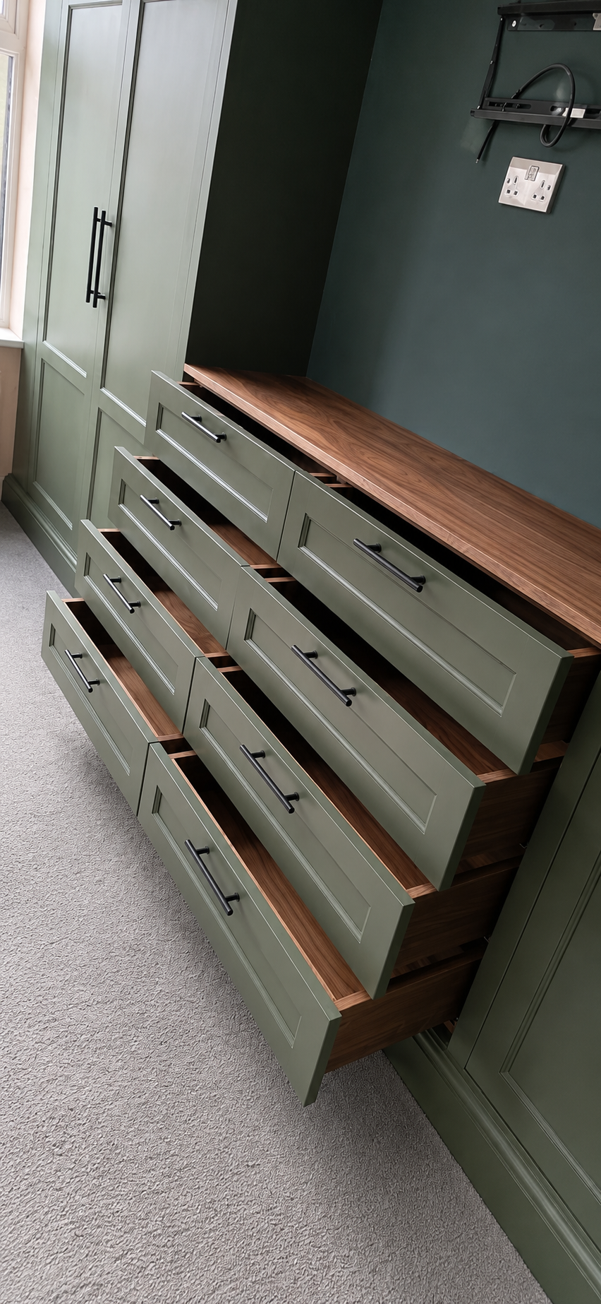 Bespoke green drawer bank with a solid walnut top and black handles